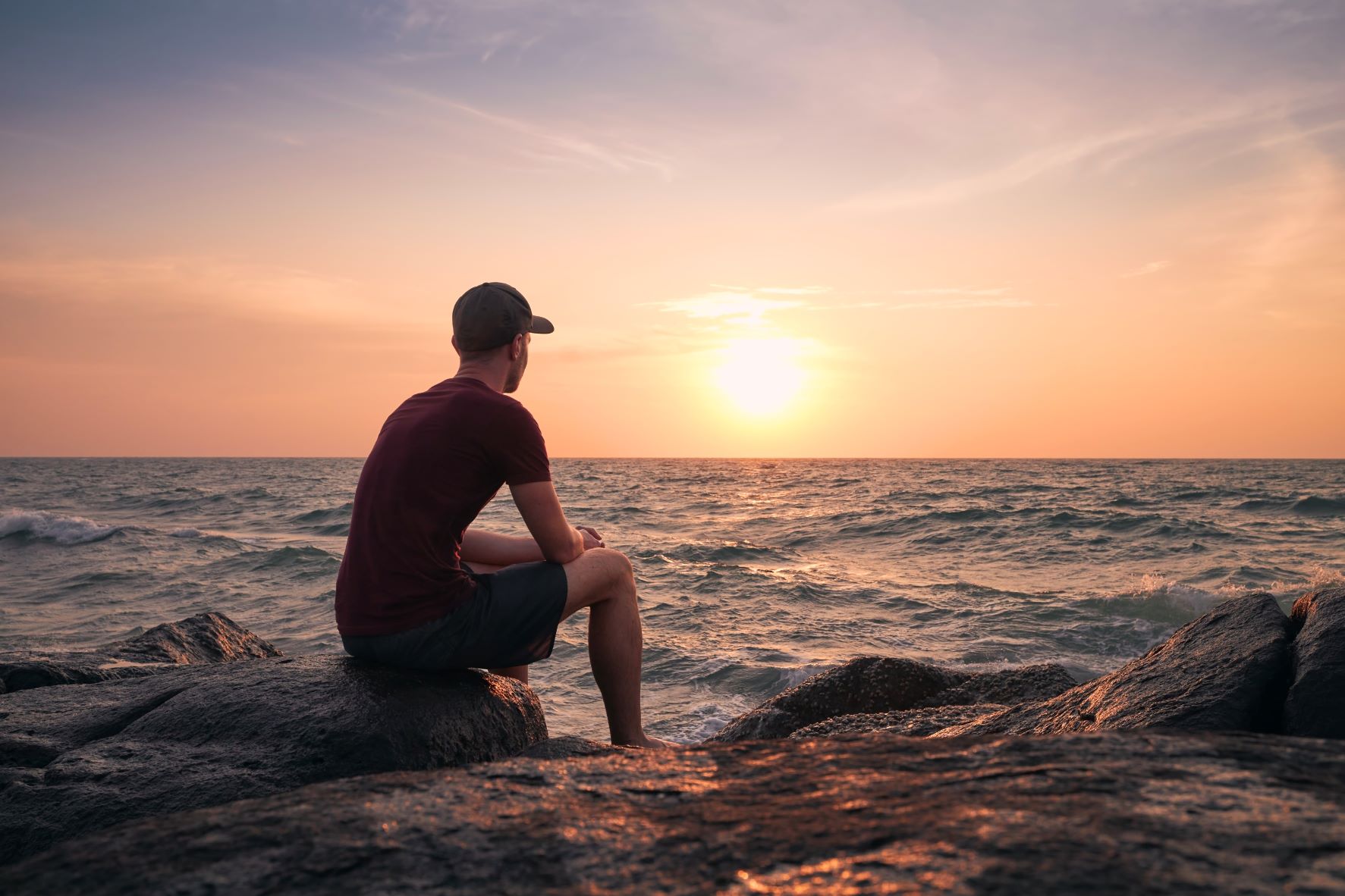 man-watching-beautiful-sunset-over-ocean-2022-10-05-21-03-46-utc_r
