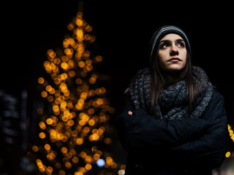 Night portrait of a sad woman feeling alone and depressed in winter.winter depression and loneliness concept