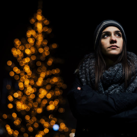 Night portrait of a sad woman feeling alone and depressed in winter.winter depression and loneliness concept